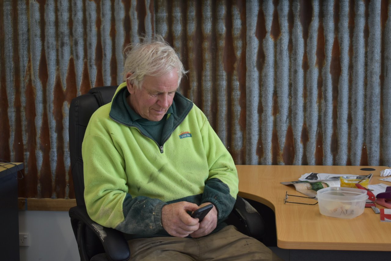 Older Man using eLearning on mobile phone.