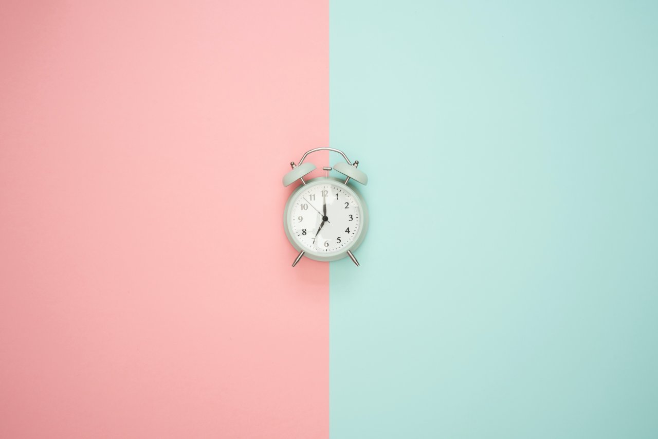 Clock on coloured background.